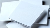 Blank white textured business cards with subtle wave pattern on light surface, mockup for corporate branding and identity design presentation.