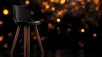 Modern black chair with wooden legs against dark background with warm glowing bokeh lights creating elegant atmosphere for interior design and furniture concepts.