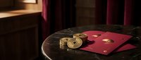 Vintage brass scales with red envelope on dark marble table in elegant interior setting with warm ambient lighting and rich textures for luxury lifestyle concepts.