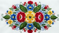 Traditional folk art floral embroidery pattern with colorful roses and decorative swirls on white background for textile design and cultural crafts.