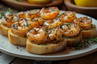 Smoked salmon rolls with cream cheese and herbs served on toasted baguette slices. Elegant appetizers garnished with fresh thyme and black sesame seeds.