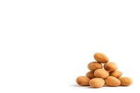 Fresh whole almonds stacked in pyramid shape on white background, isolated healthy nuts for food packaging design and marketing materials.