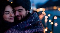 Young couple embracing outdoors at night with warm bokeh lights creating romantic winter atmosphere for Valentine's Day or holiday celebrations.
