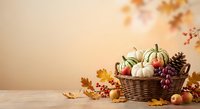 Autumn harvest basket with pumpkins, apples and fall leaves on wooden table. Seasonal thanksgiving decoration with warm colors and cozy atmosphere.
