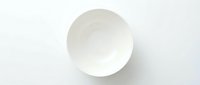Empty white ceramic bowl shot from above on a white background, isolated and ready for design use in food, kitchen, and lifestyle projects.