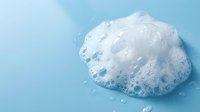 Pile of white soap bubbles and foam isolated on light blue background, suitable for cleaning product advertising and hygiene-related designs.