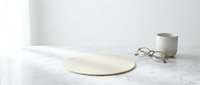 Minimalist kitchen scene with empty ceramic plate, coffee mug and reading glasses on white marble countertop for modern home interior design concepts.