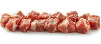 Fresh raw pork meat cubes arranged in row on white background, marbled texture visible, ready for cooking and food preparation projects.