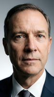 Middle-aged Caucasian male executive in formal business attire with dark suit and tie, displaying serious expression. Professional headshot for corporate, leadership, and business applications.