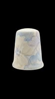 Ceramic thimble with watercolor floral design in soft blue and cream tones, isolated on transparent background. Ready for clipart, print-on-demand, and craft design projects.