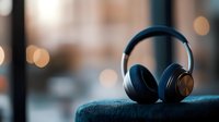 Over-ear headphones with copper accents resting on blue fabric, urban bokeh background, suitable for audio equipment marketing and tech product promotion.