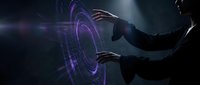 Businessman hands touching futuristic holographic interface with purple glowing circles and digital data visualization in dark technology environment.