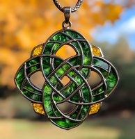 Celtic knot pendant with emerald green and amber crystals on silver chain against autumn bokeh background, showcasing intricate eternal knot design pattern.