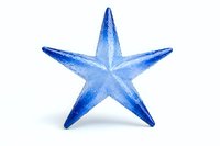 Blue crystal star shape on white background, decorative element with transparent glass effect and soft shadows, isolated object for holiday designs and festive layouts.
