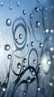 Abstract water droplets on blue surface with swirling patterns creating artistic liquid texture for modern design and wellness concepts.