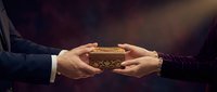 Hands exchanging ornate wooden treasure chest in dramatic lighting. Business partnership, gift giving, inheritance concept for presentations and marketing.