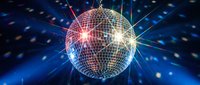 Sparkling disco ball with colorful light beams and reflections creating party atmosphere for nightclub entertainment and celebration events.