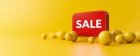 Red sale sign with yellow spheres scattered on yellow background, minimal retail marketing composition for promotional banners and advertisements.