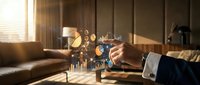Businessman analyzing financial data with holographic charts and graphs floating above desk in modern office with warm lighting.