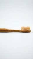 Natural bamboo toothbrush with soft bristles isolated on white background for eco-friendly dental care and sustainable oral hygiene products.