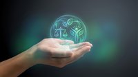 Environmental law concept with glowing scales of justice and tree symbol floating above open palm representing legal protection of nature and sustainability.
