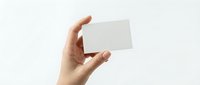 Hand holding blank white business card mockup against light background for branding and corporate identity design projects.