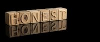 Wooden letter blocks spelling HONEST with mirror reflection on dark surface, symbolizing integrity and trustworthiness in business ethics.