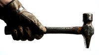 Hand gripping weathered hammer with worn wooden handle against white background. Tool for construction, repair, carpentry work isolated.
