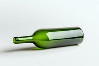 Empty green wine bottle lying horizontally on white background, minimalist composition with soft shadows and reflective glass surface. Suitable for wine industry designs.