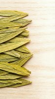 Dried okra pods arranged on light wooden surface with copy space, suitable for food styling, culinary blogs, and organic produce marketing materials.