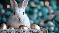 White fluffy rabbit with golden Easter eggs in wooden box against blurred turquoise background with bokeh lights, festive spring holiday composition.