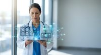 Female doctor using digital tablet with holographic medical interface displaying healthcare icons and data visualization in modern hospital setting.