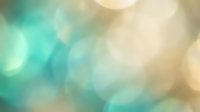 Soft bokeh background with turquoise and cream blurred lights, suitable for overlays, presentations, and design projects requiring calming atmospheric effects.