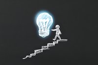 Chalk drawn stick figure climbing stairs towards glowing light bulb on blackboard, representing growth mindset, innovation and reaching goals through step-by-step progress.