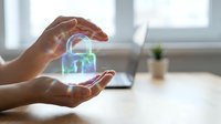 Hands holding glowing digital padlock hologram representing cybersecurity, data protection, and encryption technology for business and network safety concepts.