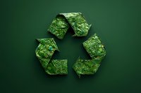 Green recycling symbol made of natural moss and plants on dark green background, representing environmental sustainability and eco-friendly concepts.