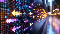 Glowing digital arrows on LED display panel with colorful bokeh lights creating dynamic movement effect against urban night background.