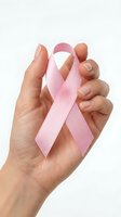 Female hand holding pink awareness ribbon symbol for breast cancer support and healthcare advocacy on white background.