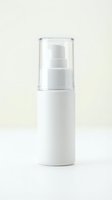 White airless pump bottle with clear cap on neutral background, suitable for cosmetics, skincare, serums, lotions, and beauty product packaging mockups.
