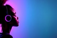 Young African American woman in profile wearing glowing purple headphones against gradient neon background from pink to blue, creating modern atmospheric mood.