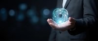 Businessman in dark suit holding glowing digital spiral orb with blue light effects, representing innovation, technology, and future business solutions.