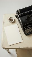 Vintage black typewriter on a rustic white desk with blank paper sheets and paper clips, evoking retro writing and journalism nostalgia.