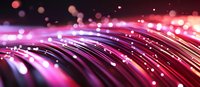 Glowing pink and red fiber optic strands with bokeh light effects against dark background create modern technology and communication concept.