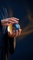 Woman holding glowing crystal ball with golden light against dark blue background, fortune telling and mystical divination concept for spiritual guidance and future prediction.