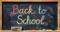 Back to school colorful chalk text on blackboard with wooden frame, eraser and chalk pieces for education and learning concepts.