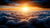 Breathtaking sunrise above fluffy white clouds with golden sunlight breaking through dramatic sky. Aerial view of cloudscape at dawn with warm orange glow.
