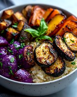 Grilled vegetables and quinoa bowl with roasted eggplant, colorful bell peppers, purple cabbage, and fresh herbs served over fluffy grain base. Fresh healthy meal.