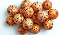 Fresh ripe lychee fruits with textured brown spotted shells arranged in group on white background, exotic tropical produce isolated for food design.