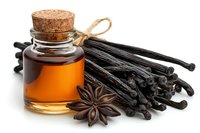 Vanilla extract in glass bottle with cork stopper alongside dried vanilla beans and star anise on white background, aromatic baking ingredients and spices.