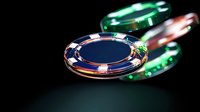 Casino poker chips floating on dark background with dramatic lighting and reflective surfaces, showing blue and green colors with selective focus for gaming atmosphere.
